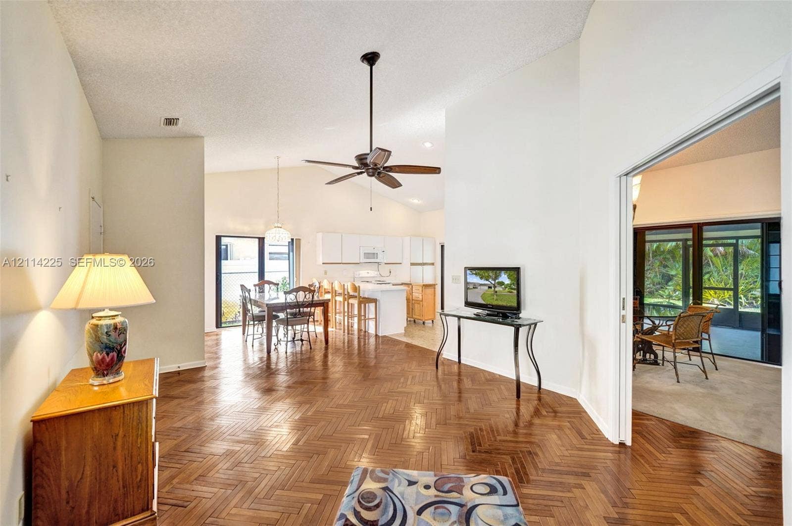 5741 SW 88th Terrace, Cooper City, FL 33328 Herringbone-patterned wood flooring, vaulted ceilings, and a central ceiling fan