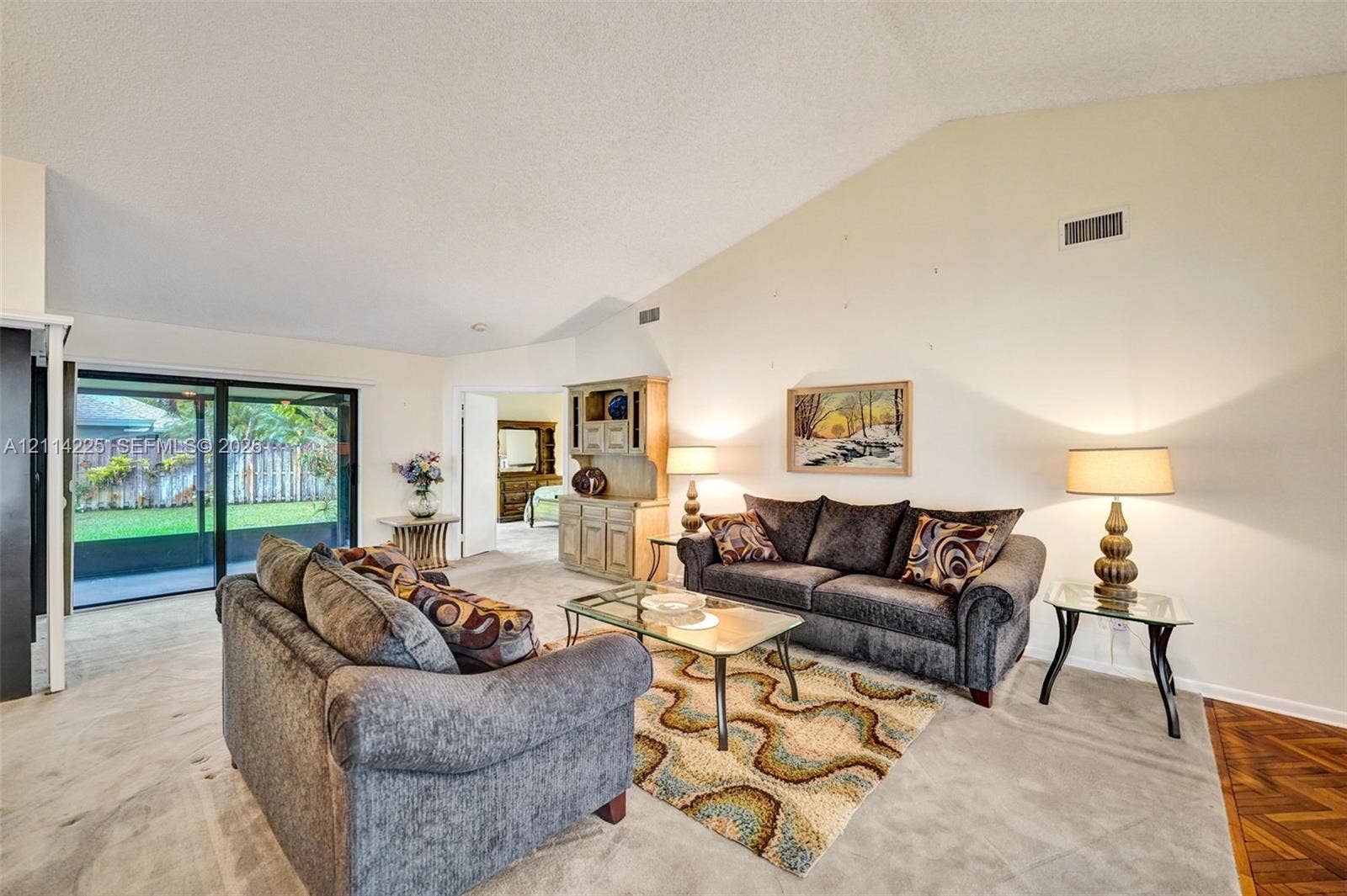 5741 SW 88th Terrace, Cooper City, FL 33328 Vaulted ceilings, sliding glass doors to the exterior, and built-in wood cabinetry