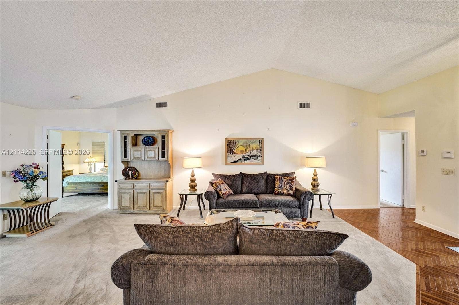 5741 SW 88th Terrace, Cooper City, FL 33328 Vaulted ceilings, built-in wooden cabinetry, and herringbone-patterned wood-finish flooring