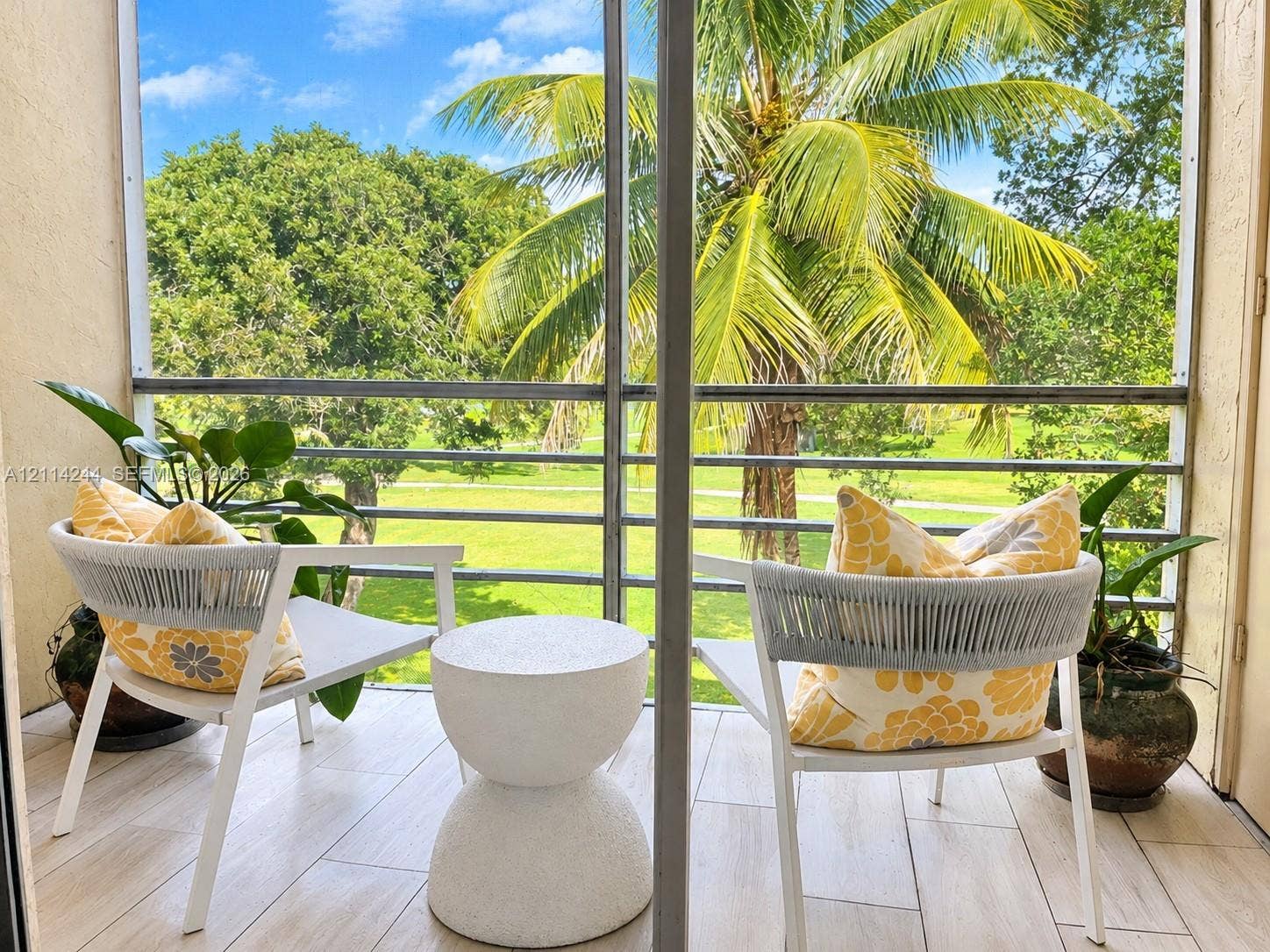15888 SW 95th Avenue, #307, Miami, Miami, FL 33157 Screened-in balcony overlooking a landscaped green space.