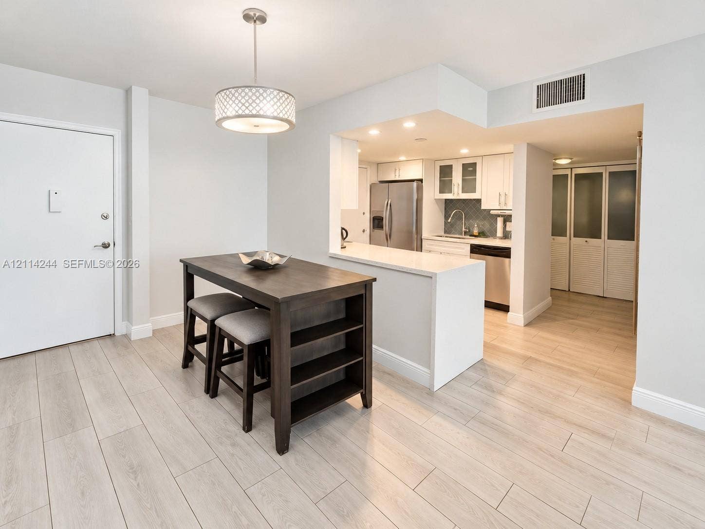 15888 SW 95th Avenue, #307, Miami, Miami, FL 33157 Dining and kitchen featuring quartz countertops, stainless steel appliances, white cabinetry.