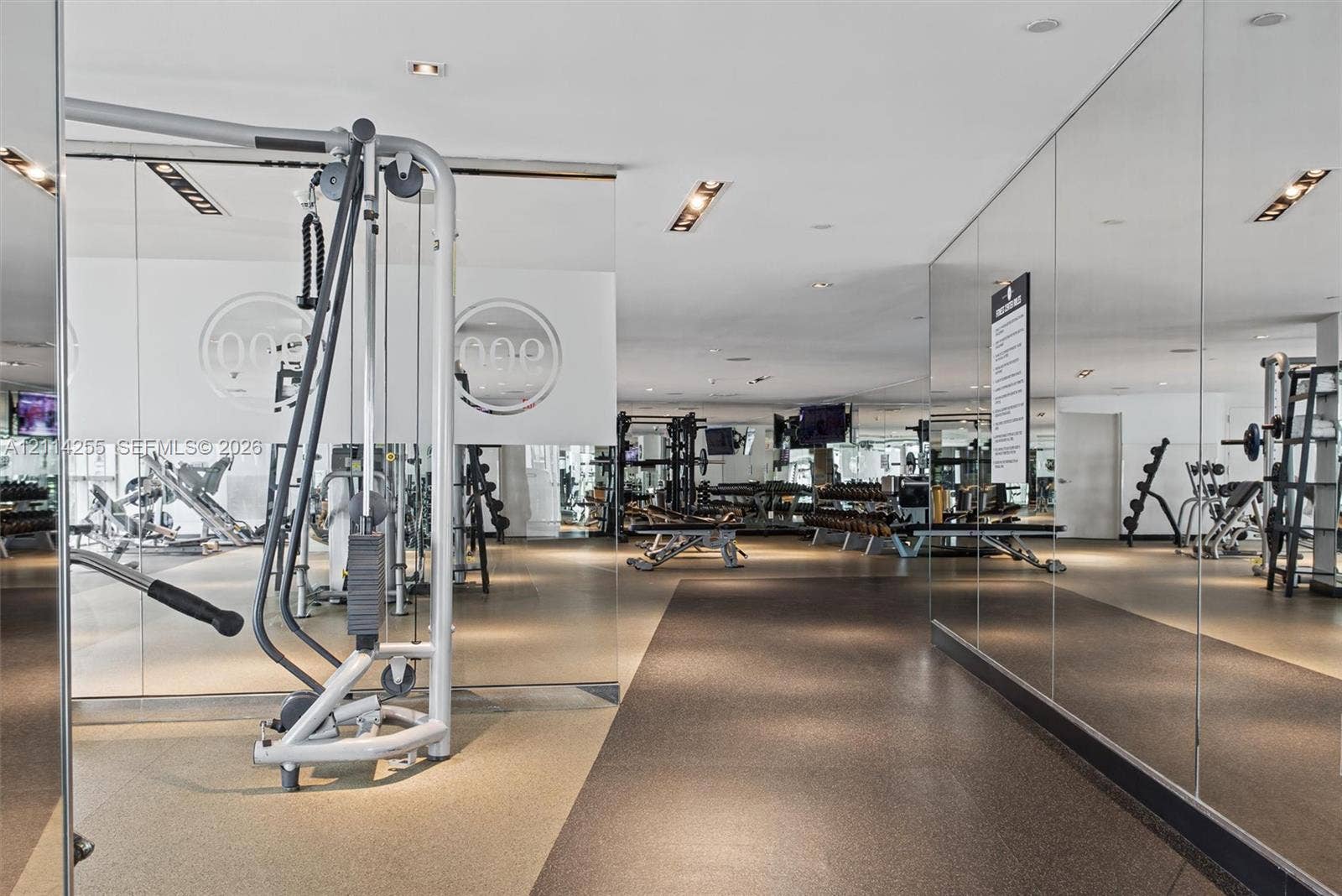 900 Biscayne Boulevard, #1705, Miami, FL 33132 Expansive fitness facility featuring wall-to-wall mirrors, recessed lighting, and durable rubber flooring