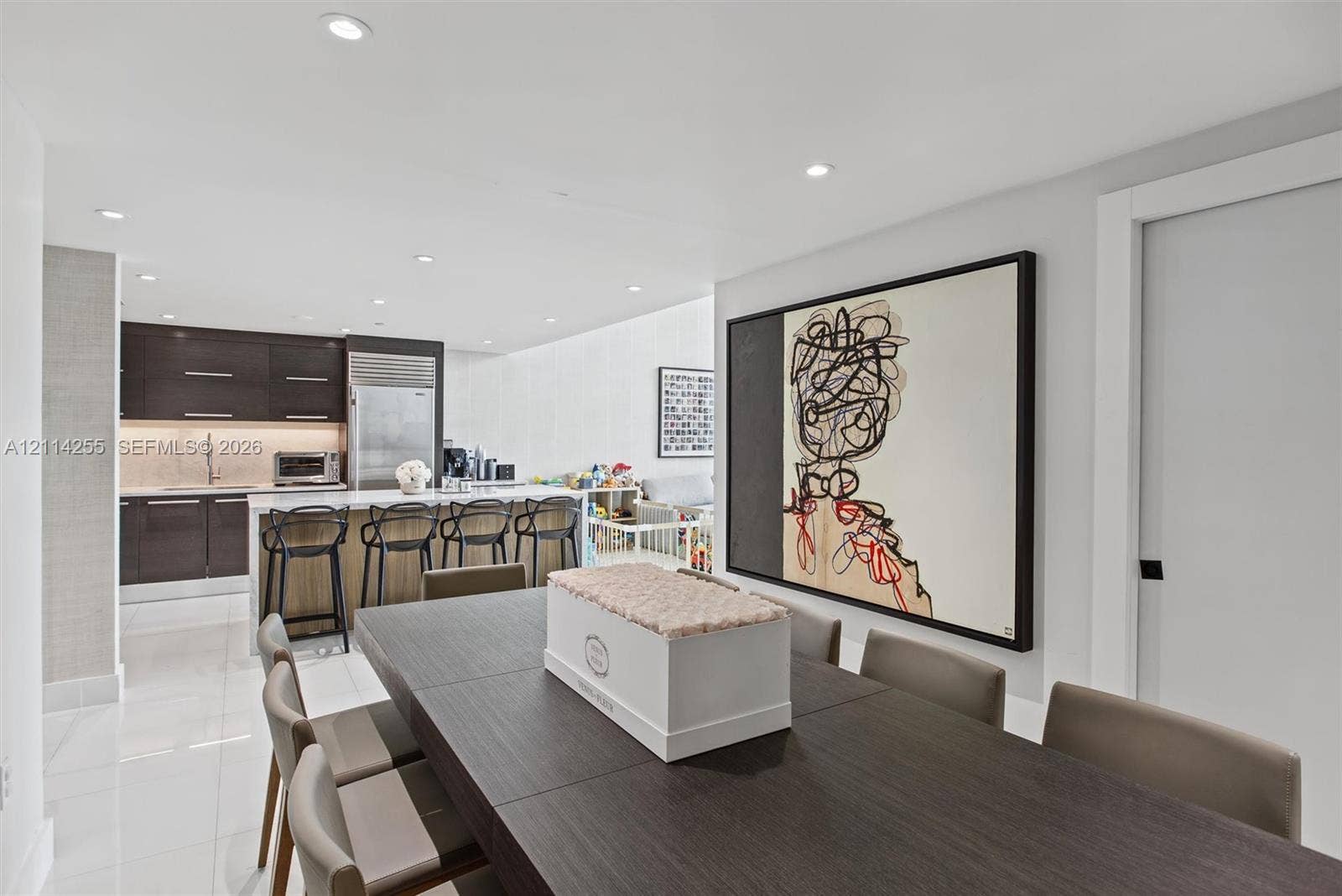 900 Biscayne Boulevard, #1705, Miami, FL 33132 Open-concept kitchen featuring high-gloss dark cabinetry, integrated refrigerator, stone countertops, and recessed lighting throughout
