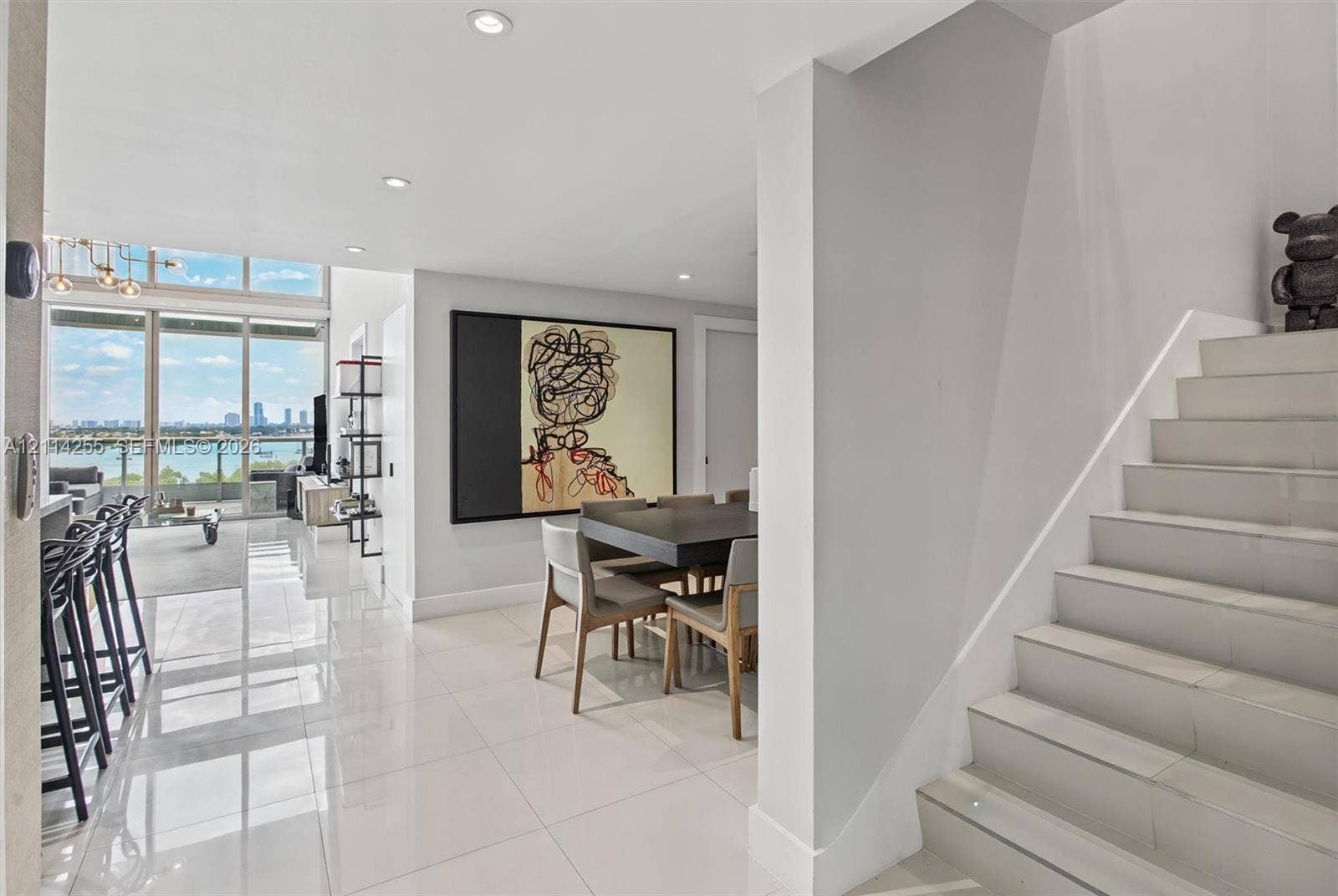900 Biscayne Boulevard, #1705, Miami, FL 33132 Polished tile flooring, floor-to-ceiling windows with water scenery, recessed lighting, and a staircase with tile treads