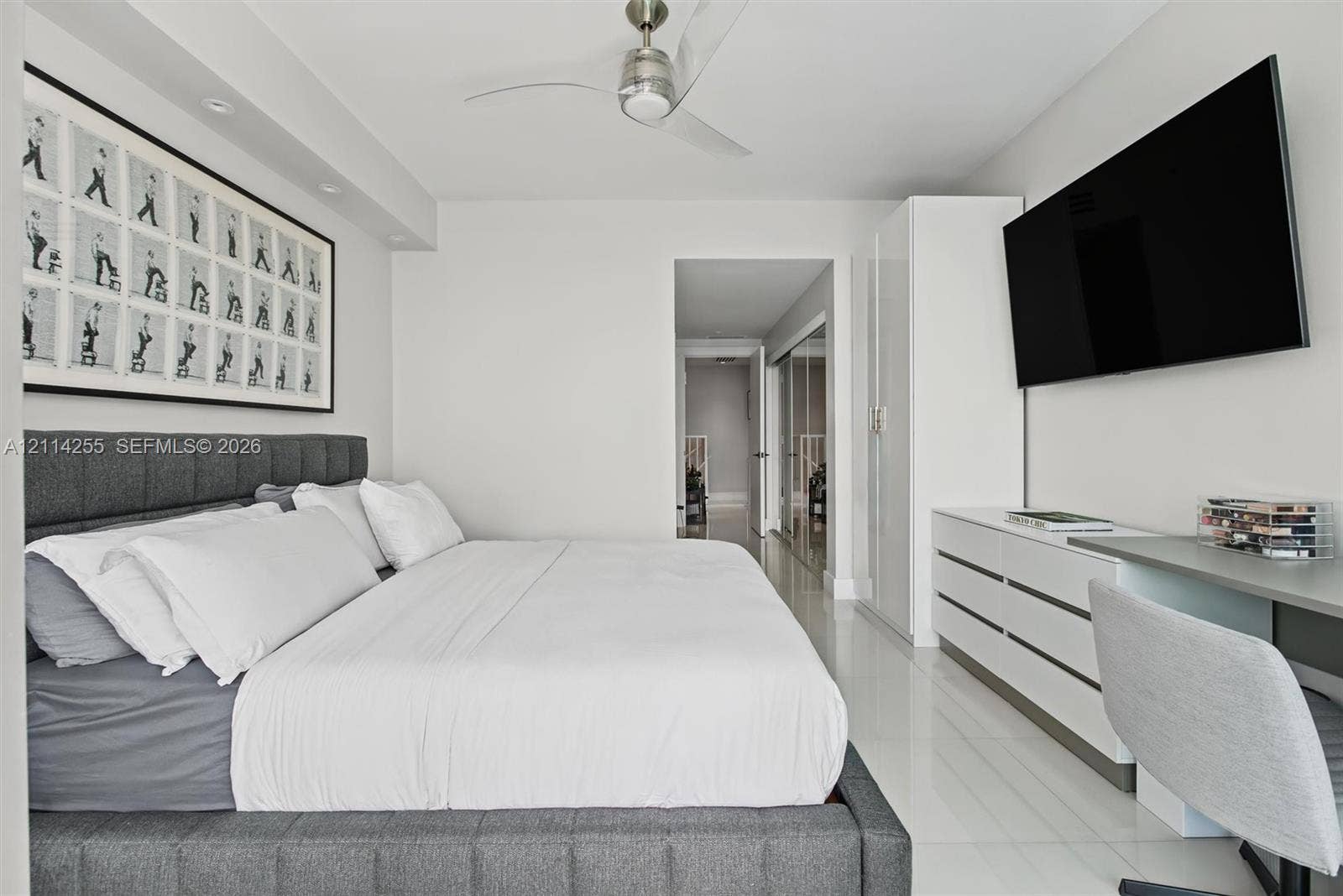 900 Biscayne Boulevard, #1705, Miami, FL 33132 Neutral-toned interior featuring polished tile flooring, recessed ceiling lighting, a contemporary brushed-metal ceiling fan, and built-in white cabinetry