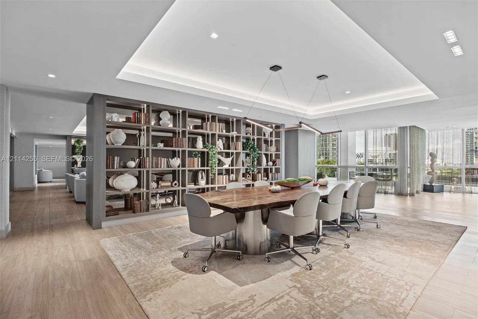 900 Biscayne Boulevard, #1705, Miami, FL 33132 Open-concept space featuring wood-finish flooring, a tray ceiling with recessed lighting, floor-to-ceiling windows, and custom floor-to-ceiling built-in shelving