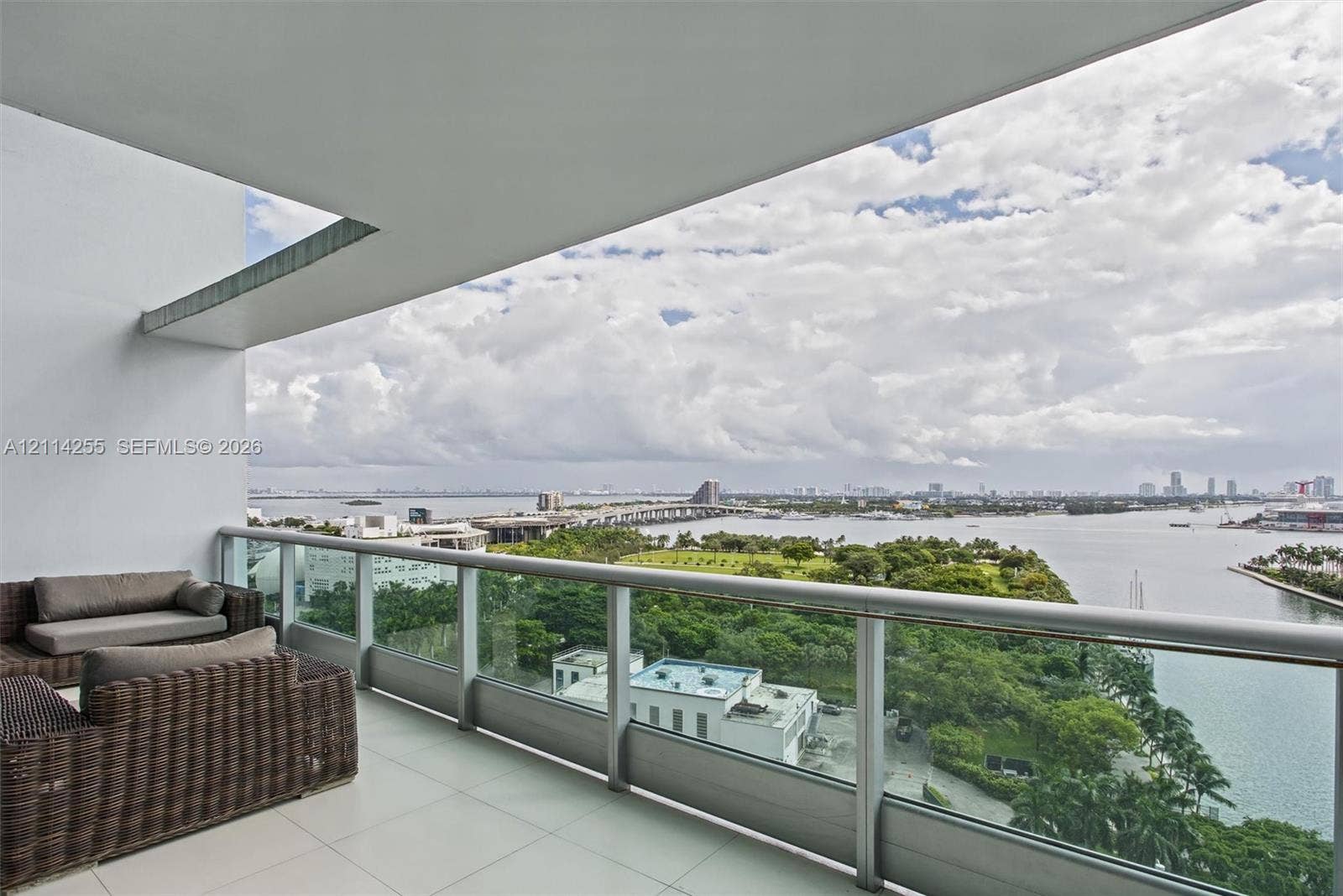 900 Biscayne Boulevard, #1705, Miami, FL 33132 Covered balcony featuring large-format tile flooring and a glass-panel railing