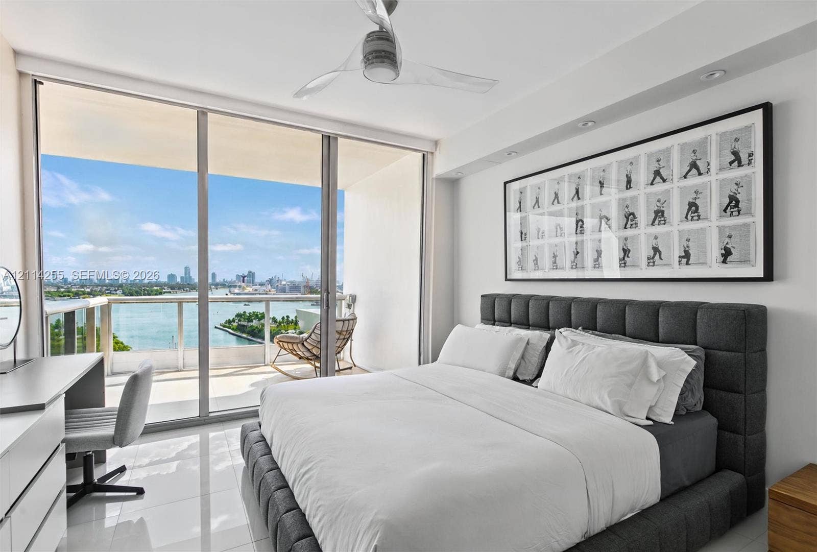 900 Biscayne Boulevard, #1705, Miami, FL 33132 Floor-to-ceiling glass sliding doors, private balcony with glass railing, polished tile flooring, and ceiling fan with integrated lighting