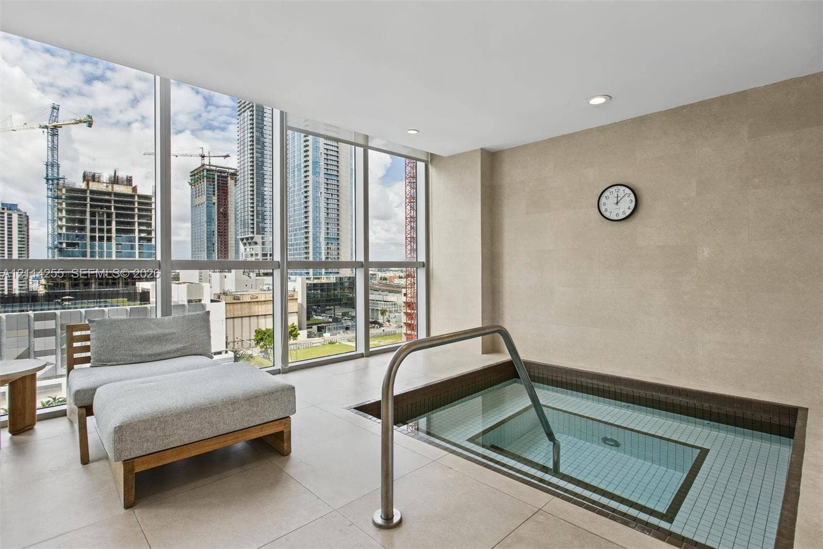 900 Biscayne Boulevard, #1705, Miami, FL 33132 In-ground plunge pool with tile lining, stainless steel handrail, floor-to-ceiling windows, and large-format tile flooring