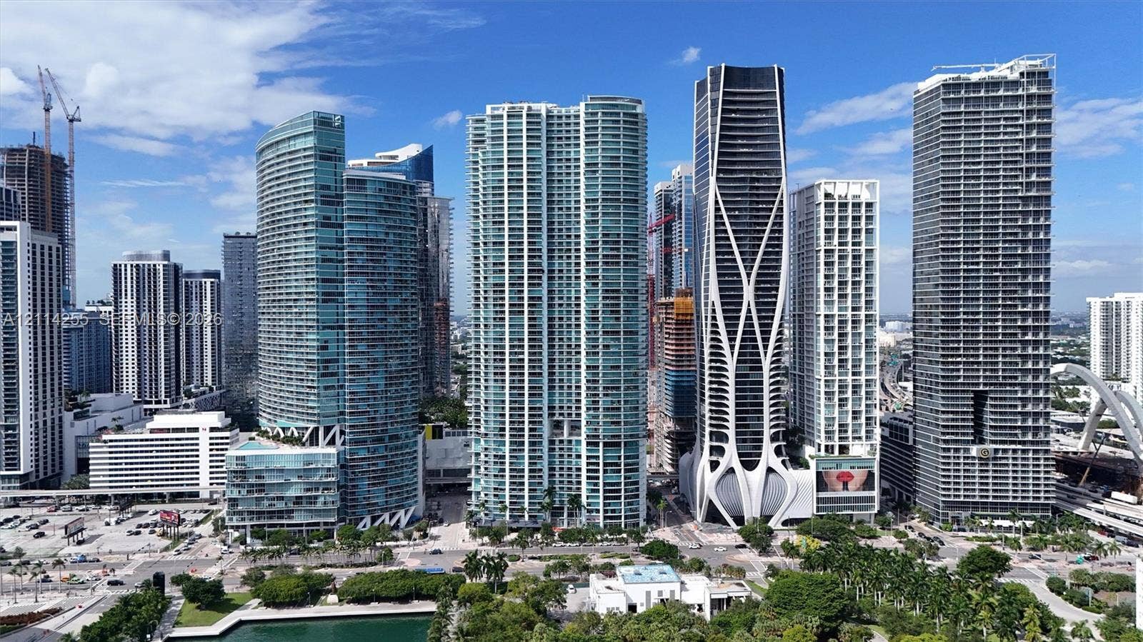 900 Biscayne Boulevard, #1705, Miami, FL 33132 High-rise urban landscape featuring contemporary glass-clad skyscrapers, integrated structural lattice design, concrete and steel facades, and water-front proximity