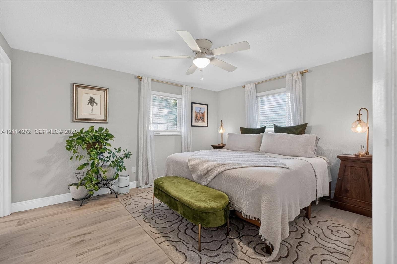 110 Cunningham, New Smyrna Beach, FL 32168 Bedroom featuring wood-finish flooring, a neutral color palette, dual windows with integrated blinds, and a central ceiling fan with an integrated light fixture