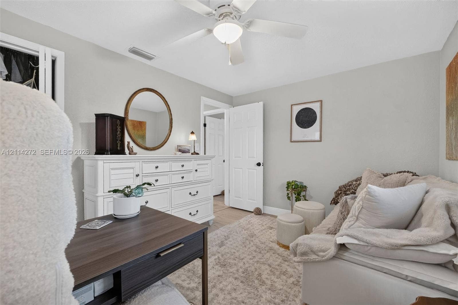 110 Cunningham, New Smyrna Beach, FL 32168 Room featuring neutral wall paint, a white four-blade ceiling fan with integrated lighting, and a six-panel interior door