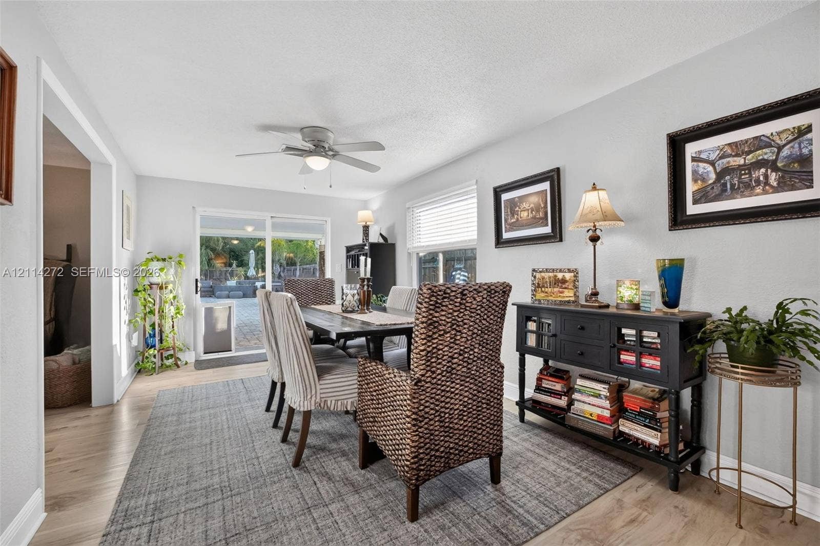 110 Cunningham, New Smyrna Beach, FL 32168 Dining area featuring wood-finish flooring, a ceiling fan with integrated lighting, and sliding glass doors
