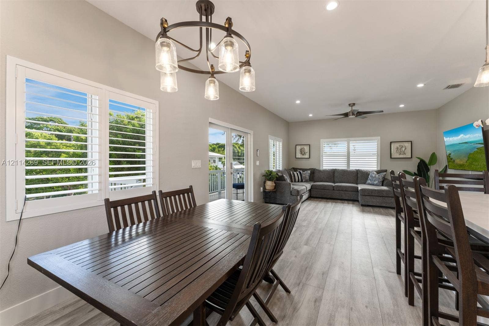 646 Cabrera Street, Key Largo, FL 33037 Open floor plan featuring wood-finish flooring, recessed lighting, plantation shutters, and a multi-light chandelier