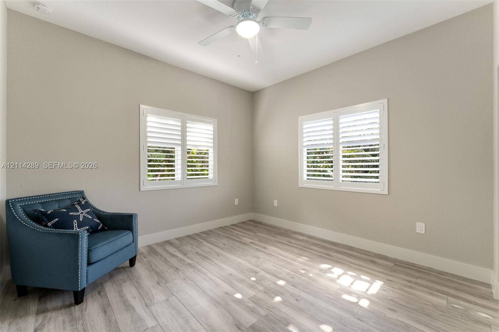 646 Cabrera Street, Key Largo, FL 33037 Neutral wall finish, wood-finish flooring, plantation shutters, and a ceiling-mounted light fixture