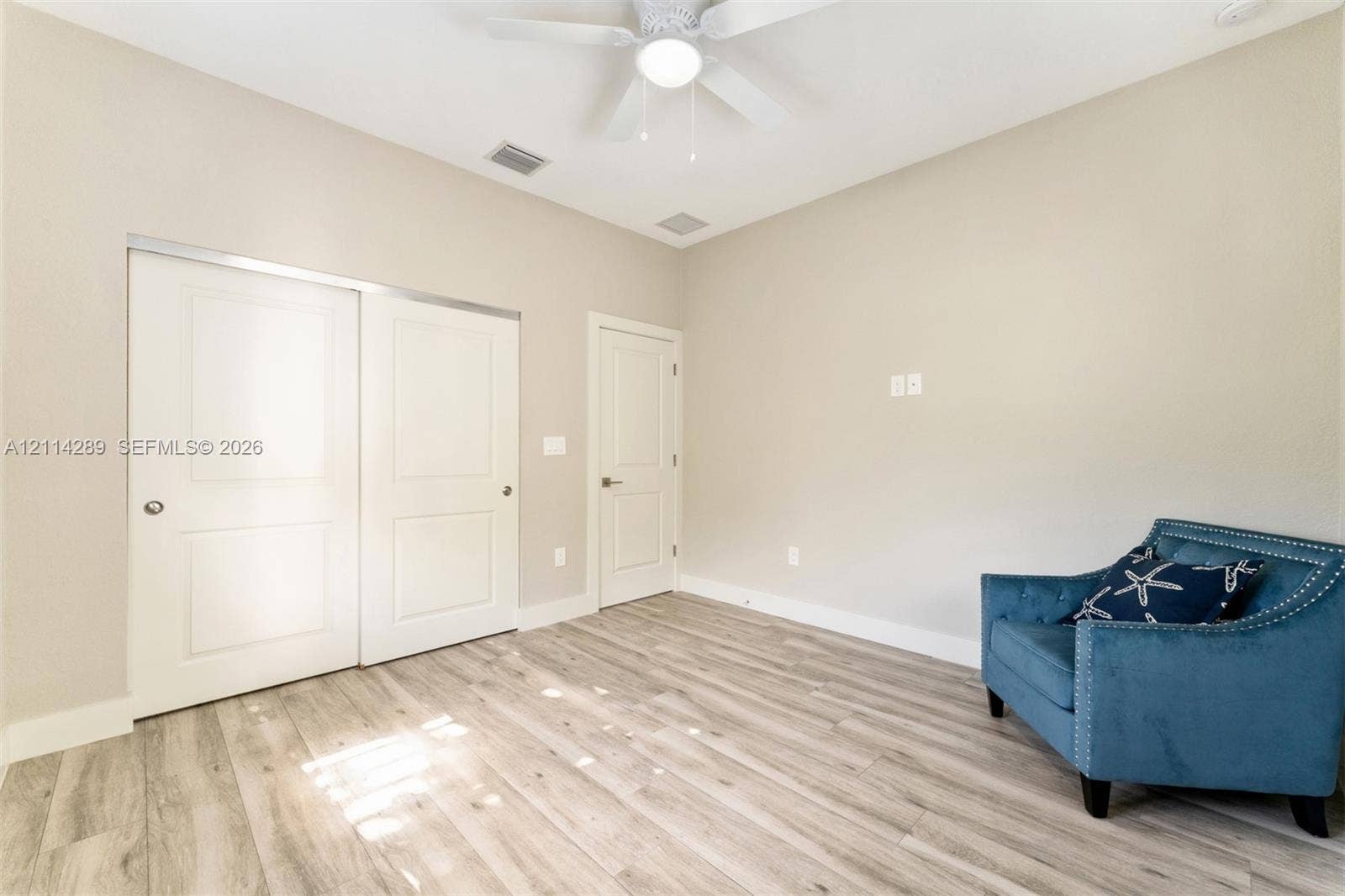 646 Cabrera Street, Key Largo, FL 33037 Room featuring wood-finish flooring, high ceilings, ceiling fan with integrated lighting, and dual-panel closet doors