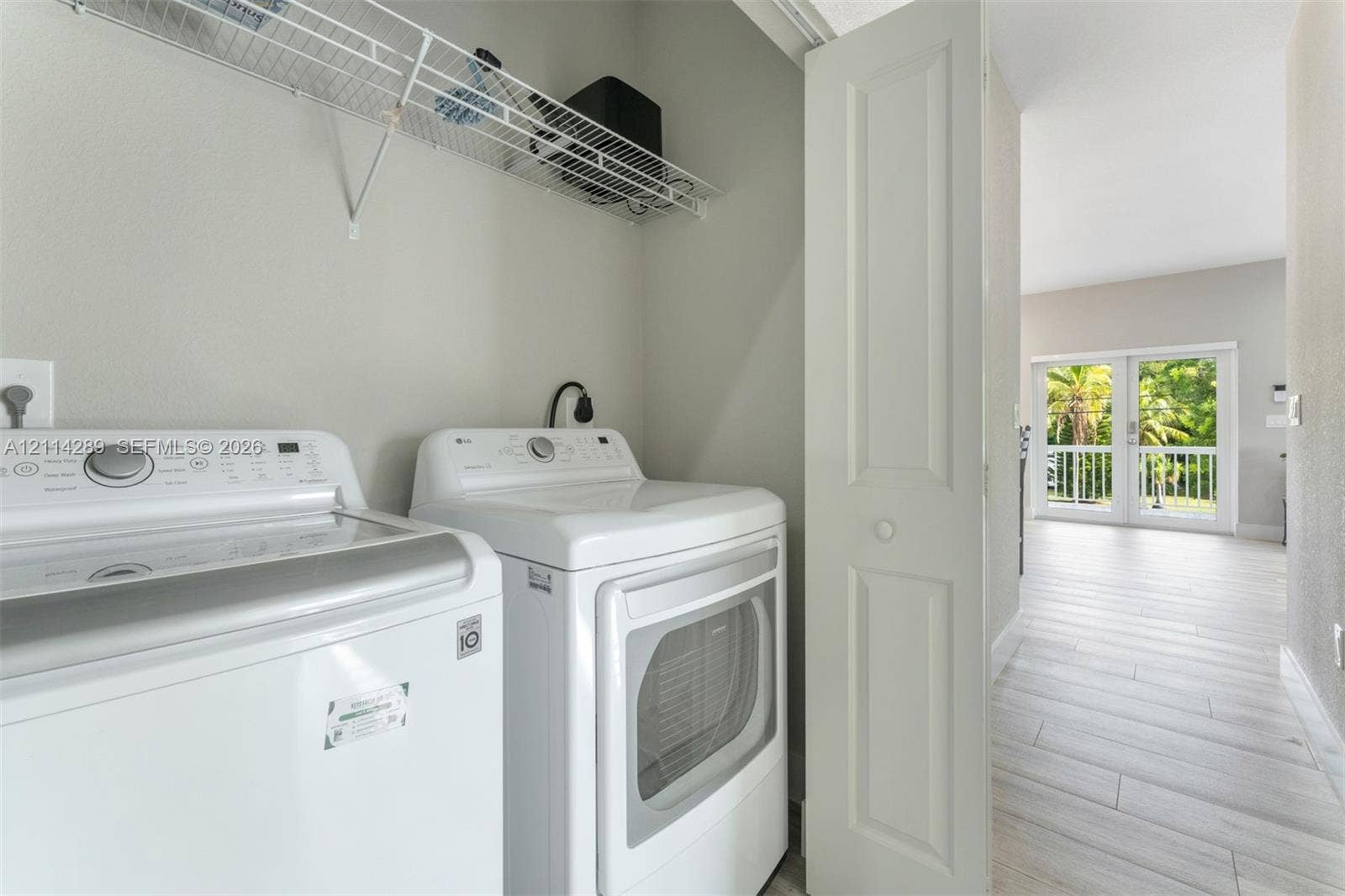 646 Cabrera Street, Key Largo, FL 33037 Laundry area featuring built-in wire shelving and light-toned wood-finish flooring