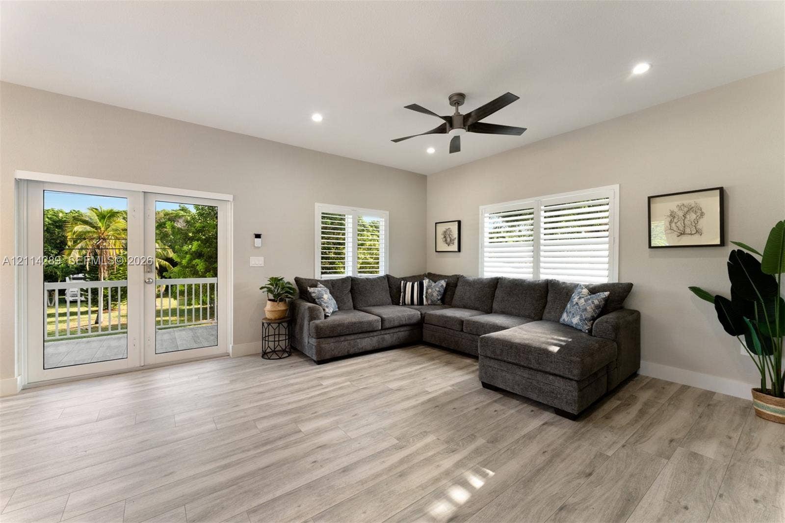 646 Cabrera Street, Key Largo, FL 33037 Living area featuring wood-finish flooring, recessed lighting, a modern ceiling fan, shutter-style window coverings, and dual glass-panel doors