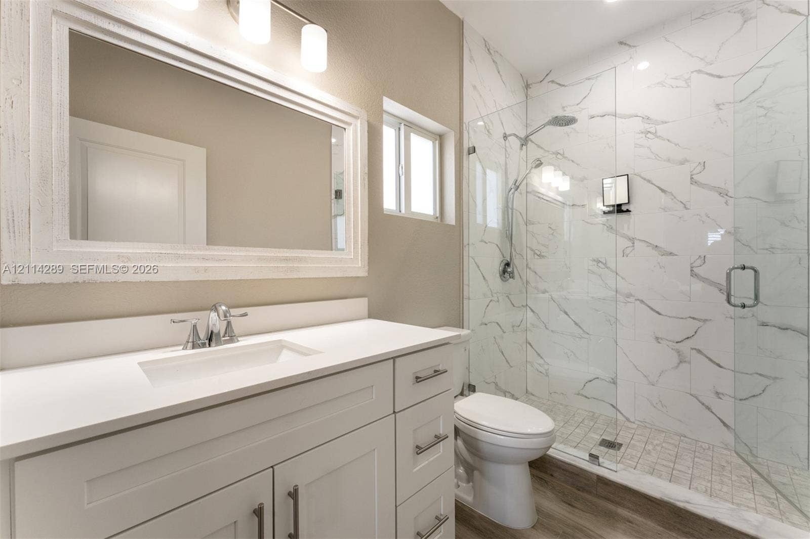 646 Cabrera Street, Key Largo, FL 33037 Bathroom featuring a vanity with white cabinetry, a rectangular sink, and a solid-surface countertop