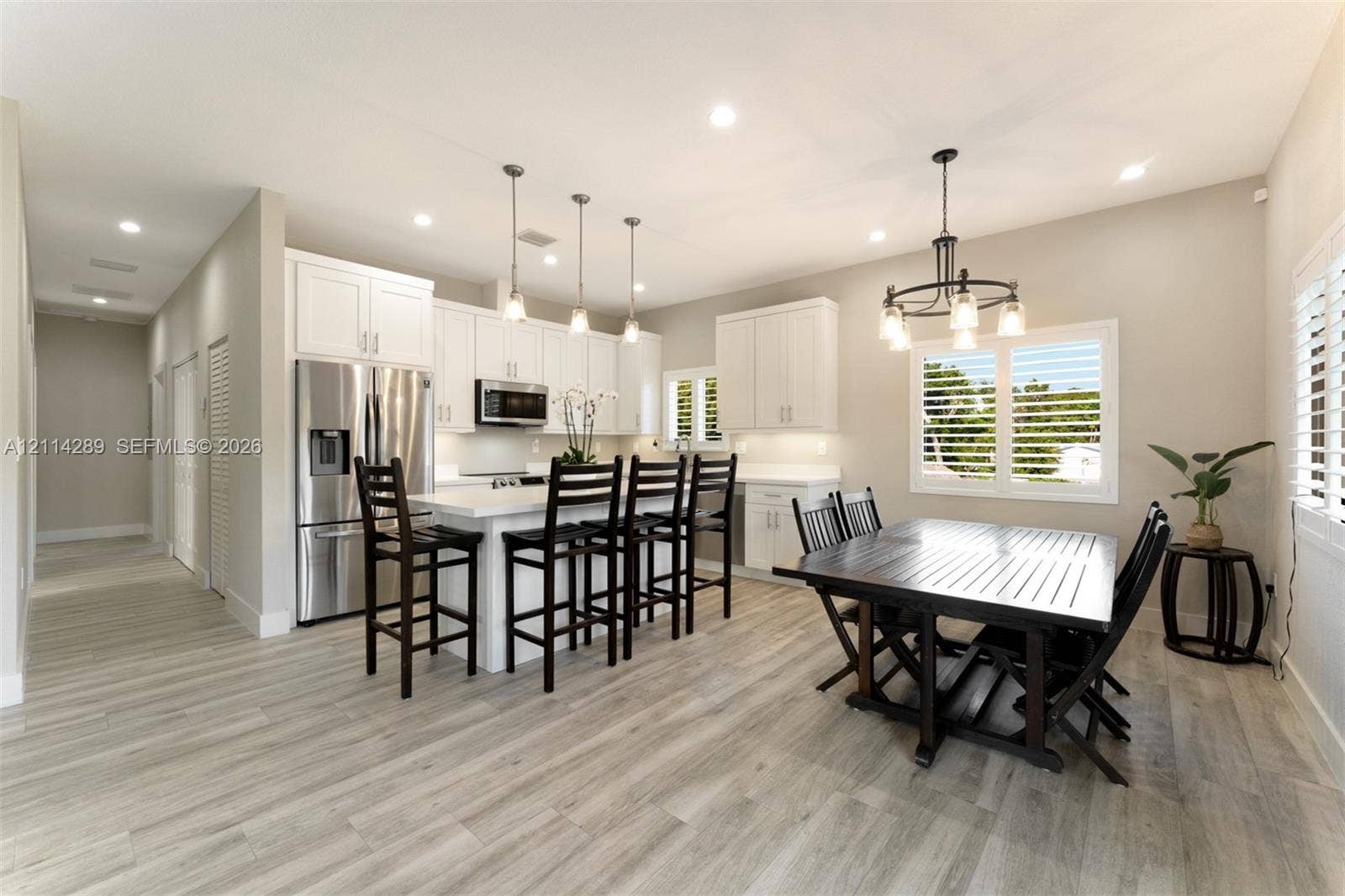 646 Cabrera Street, Key Largo, FL 33037 Kitchen featuring white cabinetry, stone countertops, stainless steel appliances, wood-finish flooring, and recessed lighting