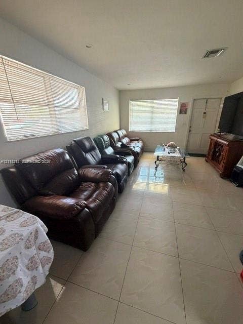 2312 Van Buren Street, #11, Hollywood, FL 33020 Large-format neutral tile flooring throughout with recessed lighting and multiple windows featuring horizontal blinds