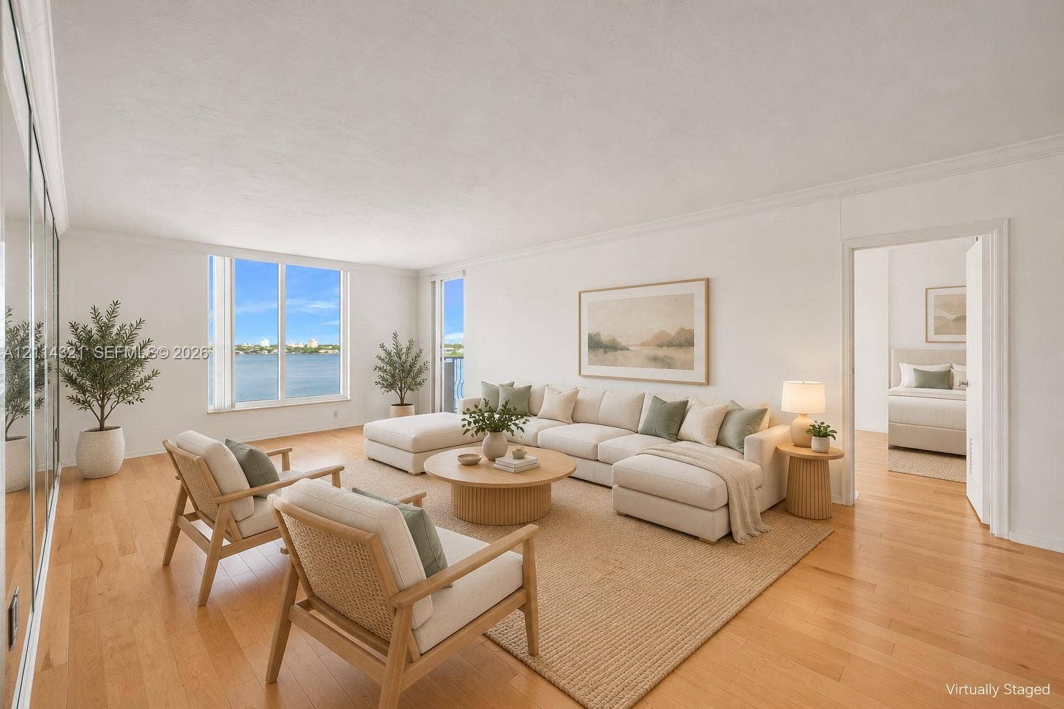10350 W Bay Harbor Drive, #9C, Bay Harbor Islands, FL 33154 Living area featuring wood-finish flooring, floor-to-ceiling mirrored wall paneling, and expansive windows with water scenery