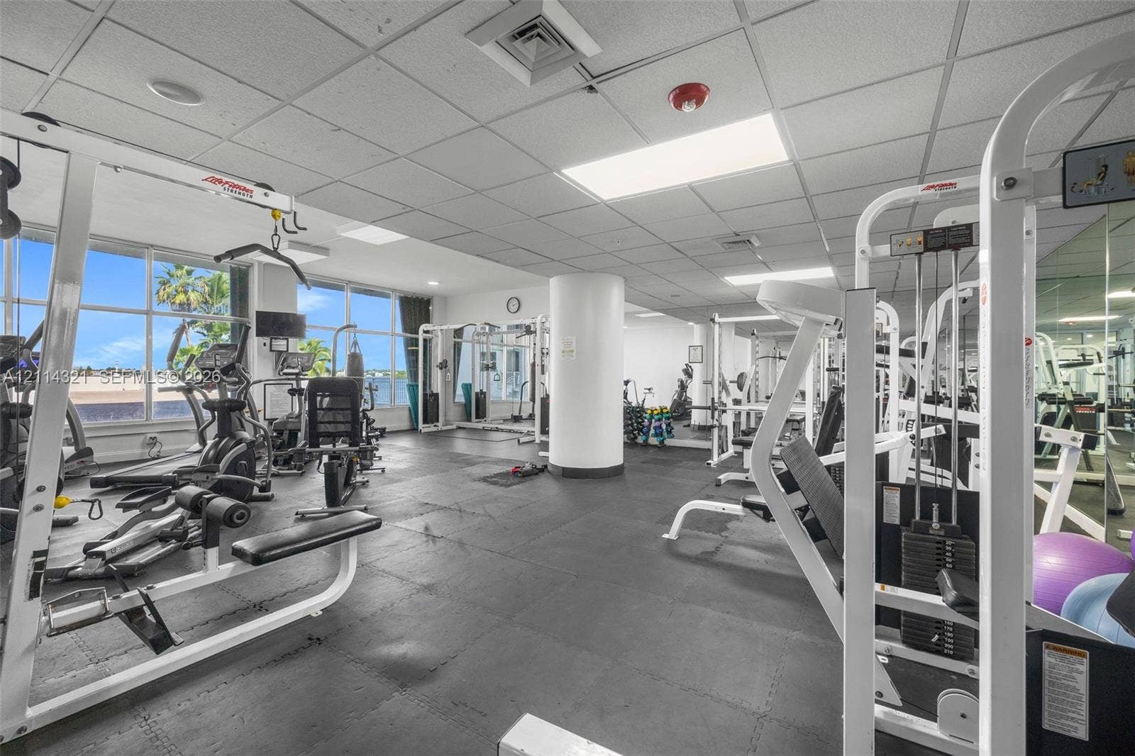 10350 W Bay Harbor Drive, #9C, Bay Harbor Islands, FL 33154 Fitness center featuring rubber flooring, floor-to-ceiling windows, and wall-to-wall mirrors