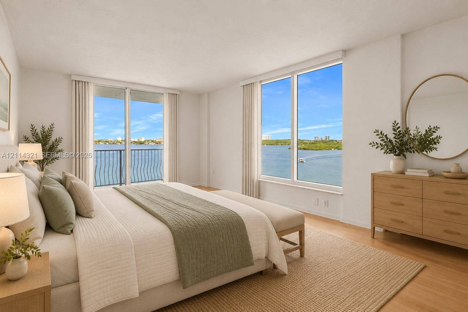 10350 W Bay Harbor Drive, #9C, Bay Harbor Islands, FL 33154 Spacious bedroom featuring light wood-finish flooring, floor-to-ceiling windows with water scenery, and a private balcony with metal railing
