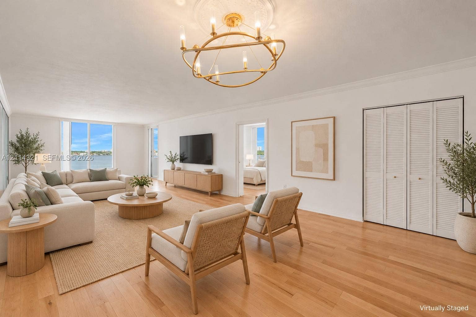 10350 W Bay Harbor Drive, #9C, Bay Harbor Islands, FL 33154 Living area featuring light-toned wood-finish flooring, a modern gold-tone circular chandelier, crown molding, and floor-to-ceiling windows