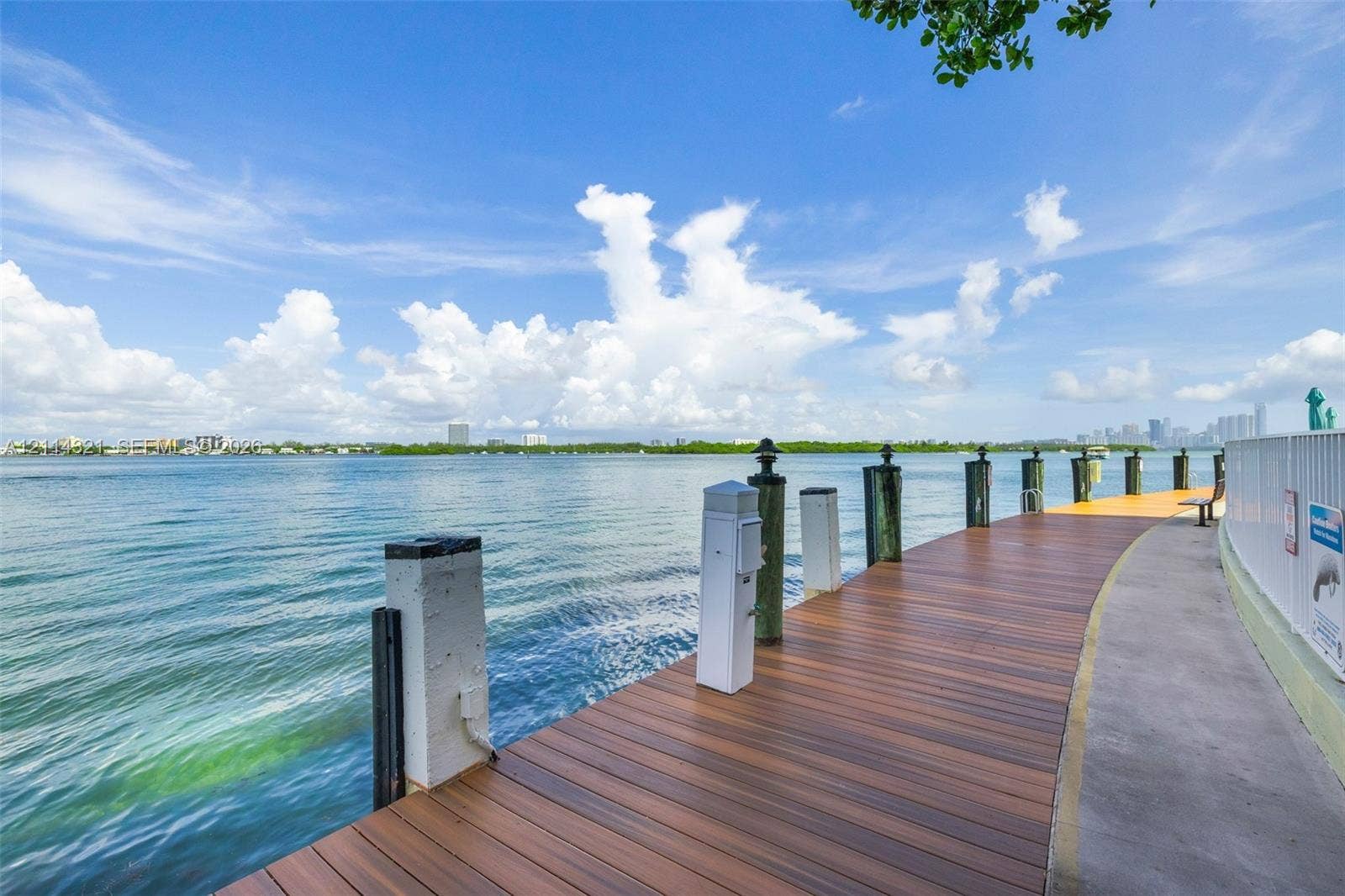 10350 W Bay Harbor Drive, #9C, Bay Harbor Islands, FL 33154 Waterfront wooden deck featuring built-in lighting and nautical pilings