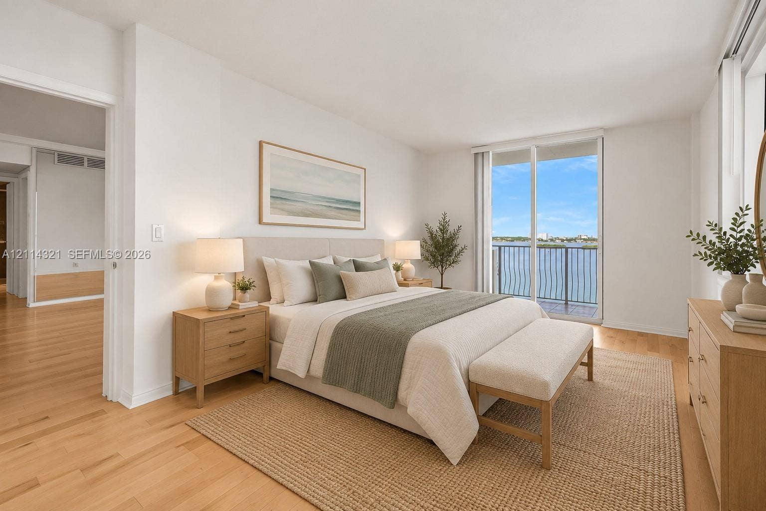 10350 W Bay Harbor Drive, #9C, Bay Harbor Islands, FL 33154 Neutral-toned room featuring wood-finish flooring, floor-to-ceiling glass sliding doors, and a private balcony with metal railing