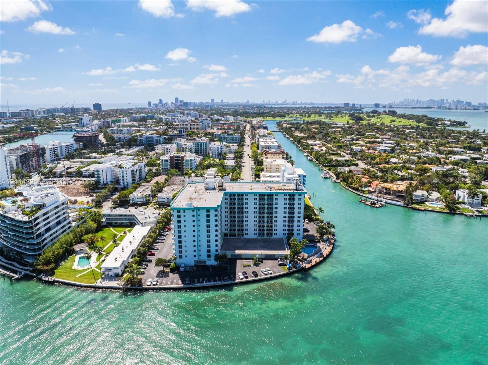 10350 W Bay Harbor Drive, #9C, Bay Harbor Islands, FL 33154 High-rise coastal building featuring waterfront positioning, expansive marine exposure, surface parking, and a dedicated pool area