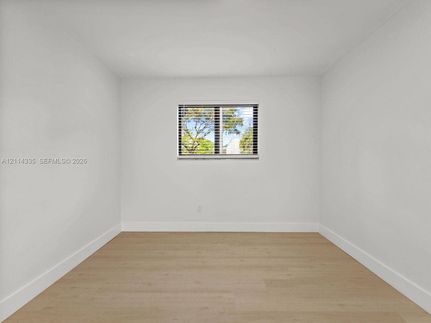 2930 Day Avenue, #N102, Miami, Miami, FL 33133 Neutral wall palette, wood-finish flooring, and single-pane window with horizontal blinds