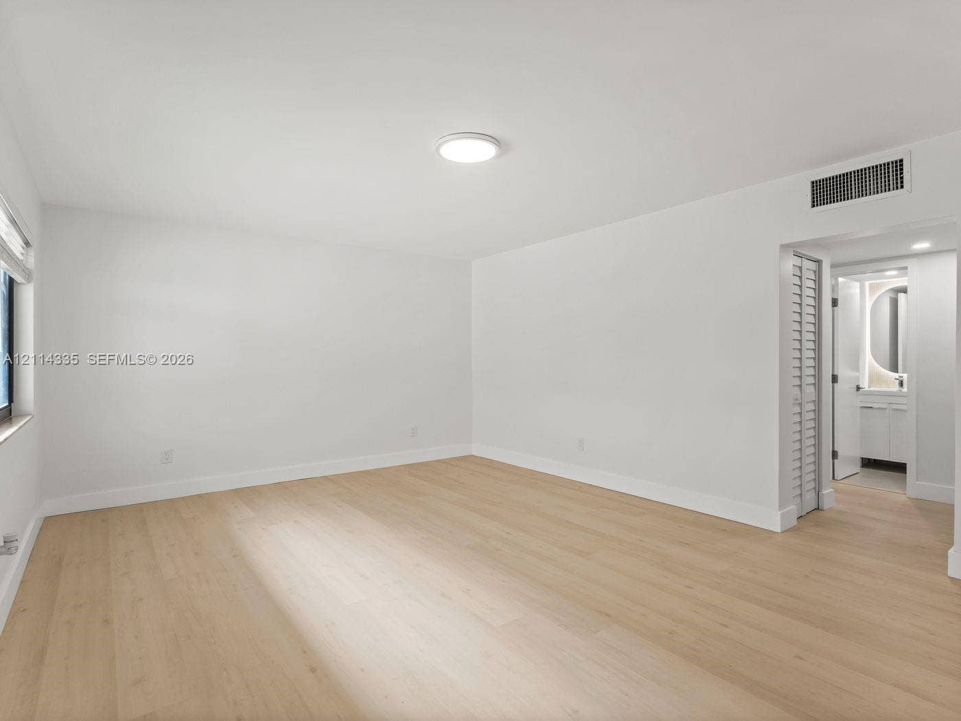 2930 Day Avenue, #N102, Miami, Miami, FL 33133 Room featuring wood-finish flooring, a neutral color palette, recessed lighting, and a louvered closet door