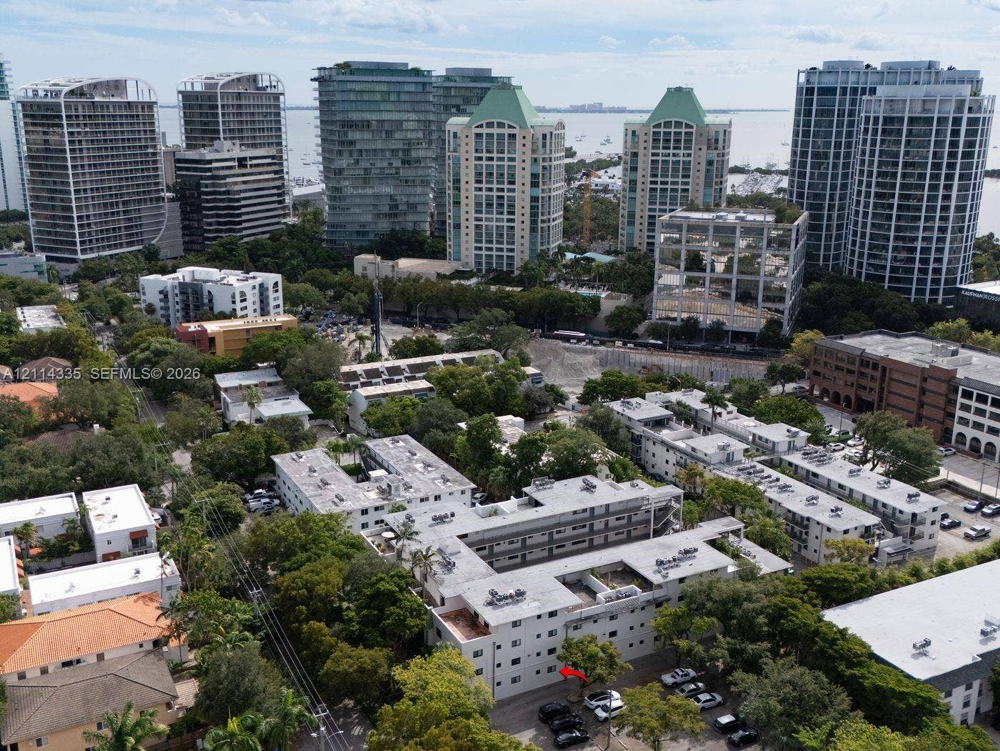 2930 Day Avenue, #N102, Miami, Miami, FL 33133 Aerial perspective featuring multi-story residential structures, mature tree canopy, and proximity to the waterfront
