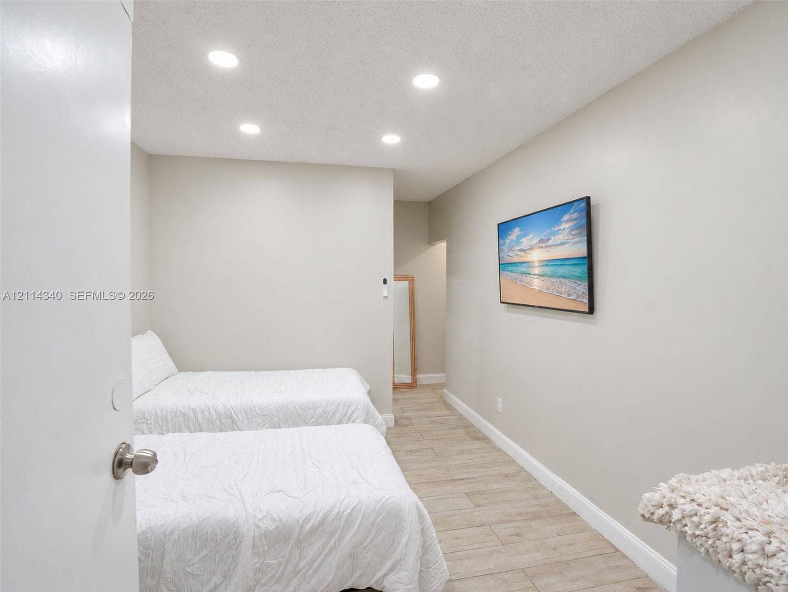 3586 SW 50th Street, Hollywood, FL 33312 Interior room featuring wood-finish tile flooring, neutral wall paint, and recessed ceiling lighting
