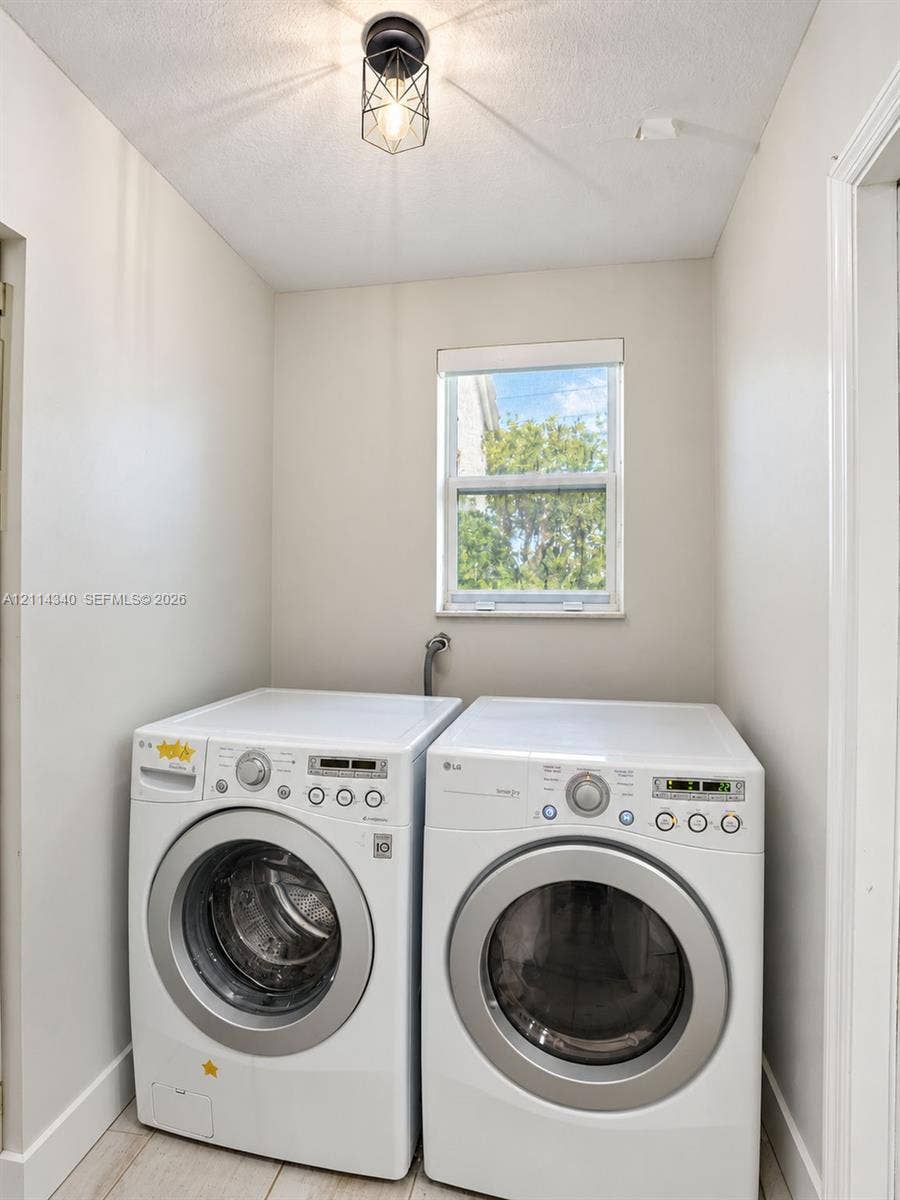3586 SW 50th Street, Hollywood, FL 33312 Dedicated laundry space featuring neutral wall paint, a single window, and a geometric-frame ceiling light fixture
