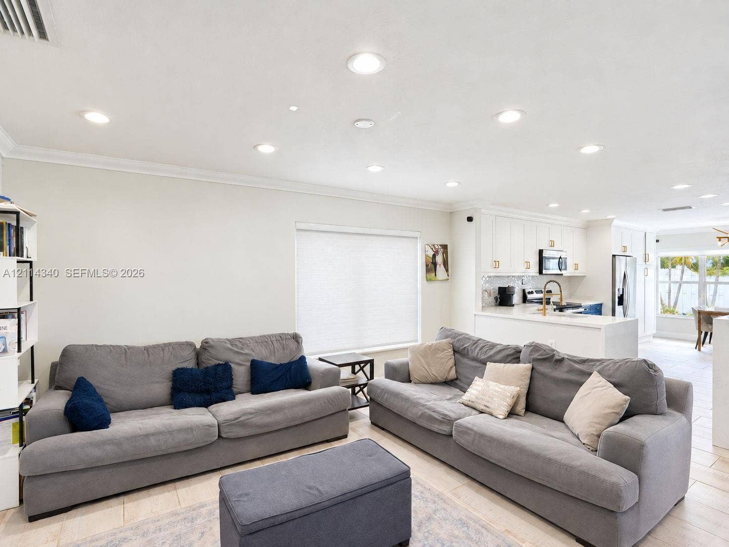 3586 SW 50th Street, Hollywood, FL 33312 Open-concept interior featuring recessed lighting, crown molding, neutral wall finishes, tile flooring, and white cabinetry