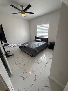 Large-format polished tile flooring with neutral veining, multi-speed ceiling fan with integrated light fixture, and horizontal-slat window treatment