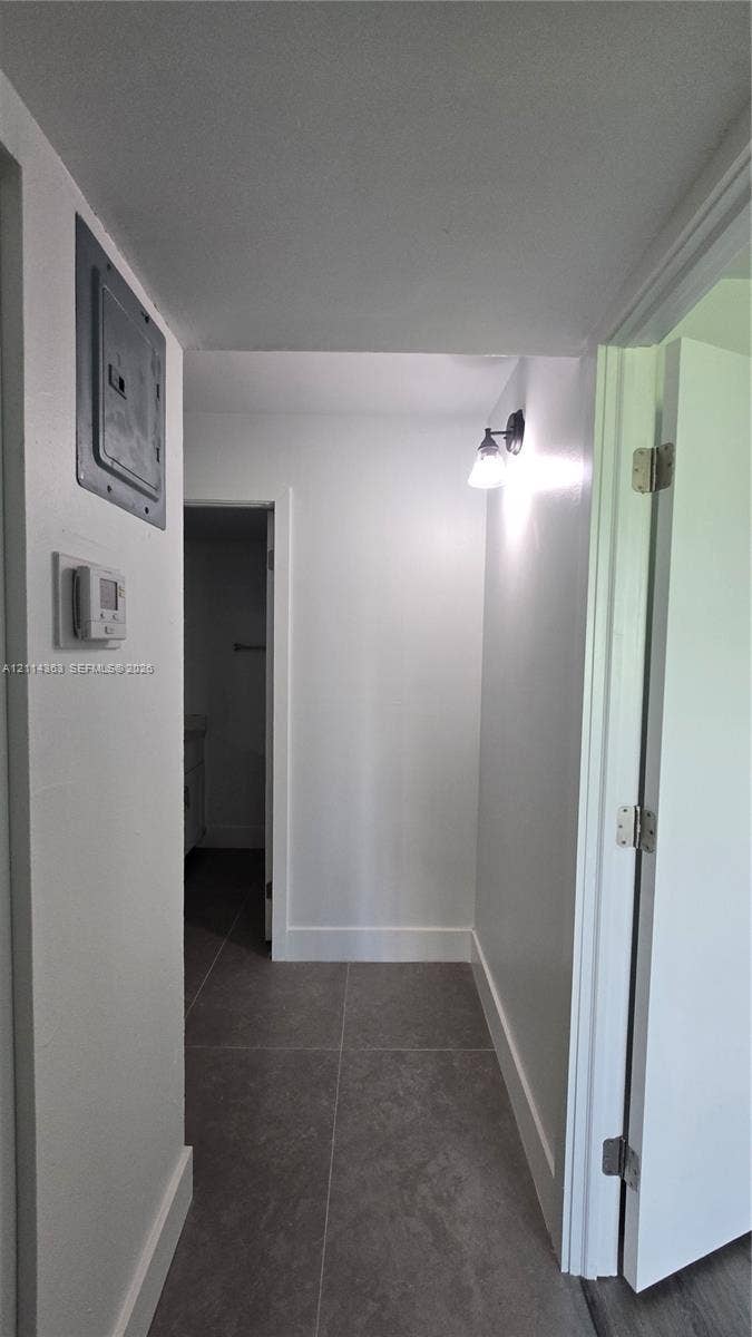 14840 Naranja Lakes Boulevard, #1G, Homestead, FL 33032 Neutral-toned large-format tile flooring and wall-mounted sconce lighting