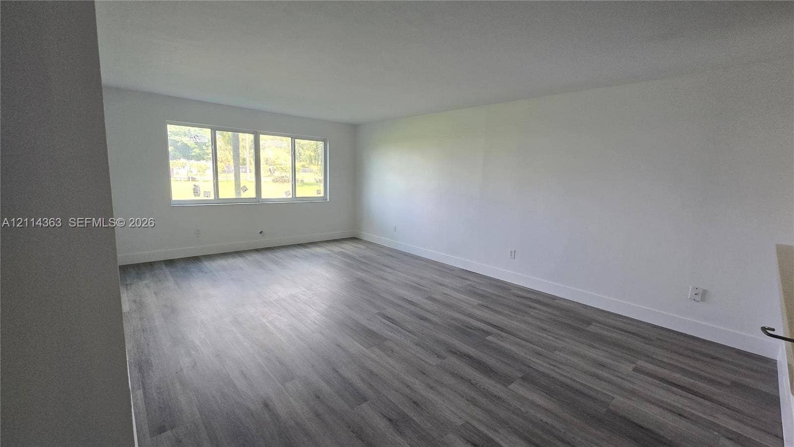 14840 Naranja Lakes Boulevard, #1G, Homestead, FL 33032 Neutral interior featuring wood-finish flooring and a multi-pane window