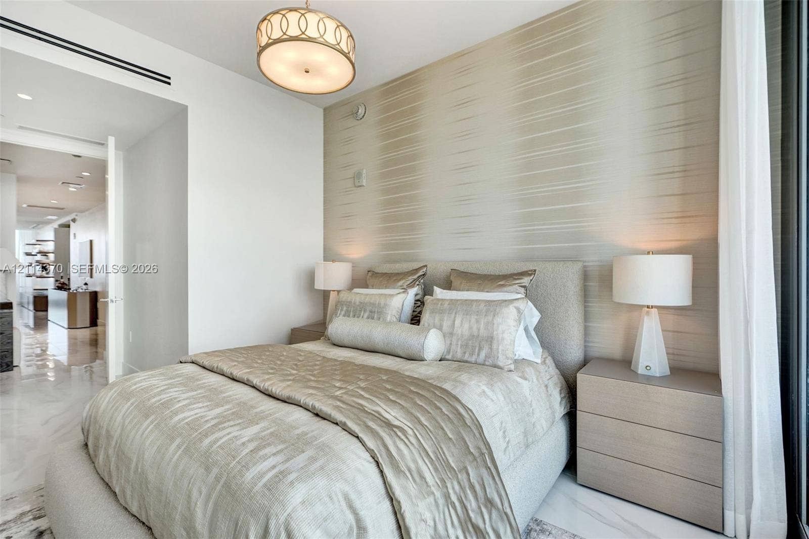 Sunny Isles Beach, Sunny Isles Beach, FL 33160 Textured wall treatment, polished stone flooring, and custom circular pendant lighting