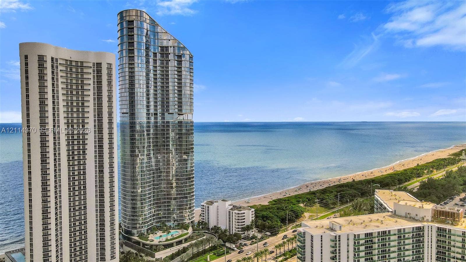 Sunny Isles Beach, Sunny Isles Beach, FL 33160 High-rise exterior with glass curtain wall facade, expansive ocean frontage, and integrated swimming pool