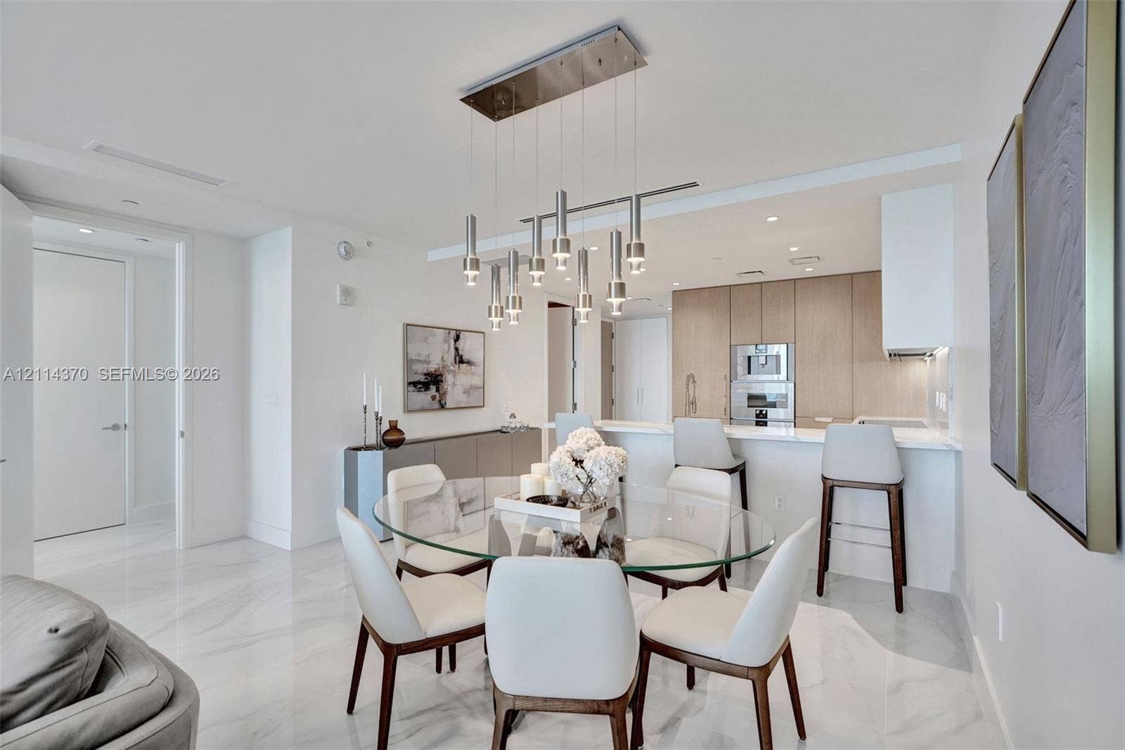 Sunny Isles Beach, Sunny Isles Beach, FL 33160 Large-format tile flooring, contemporary multi-pendant lighting fixture, flat-panel cabinetry, and integrated stainless steel appliances