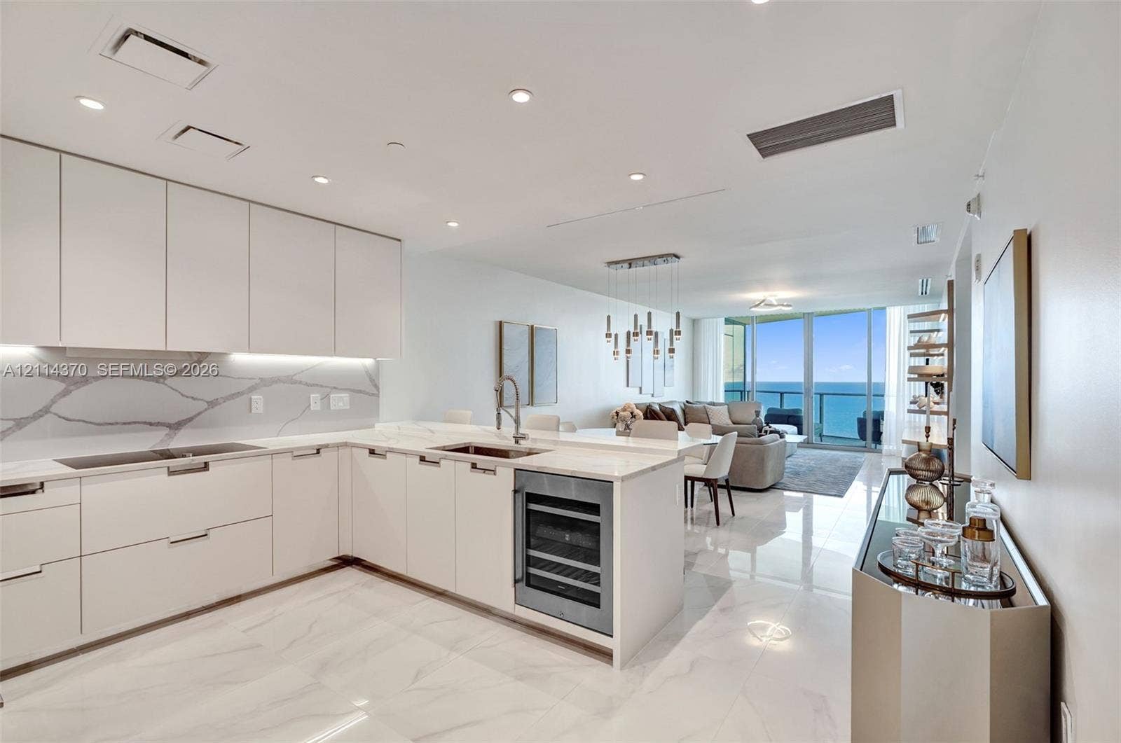 Sunny Isles Beach, Sunny Isles Beach, FL 33160 Kitchen featuring flat-panel cabinetry, stone-patterned backsplash, built-in wine refrigerator, under-cabinet lighting, and polished stone-finish flooring