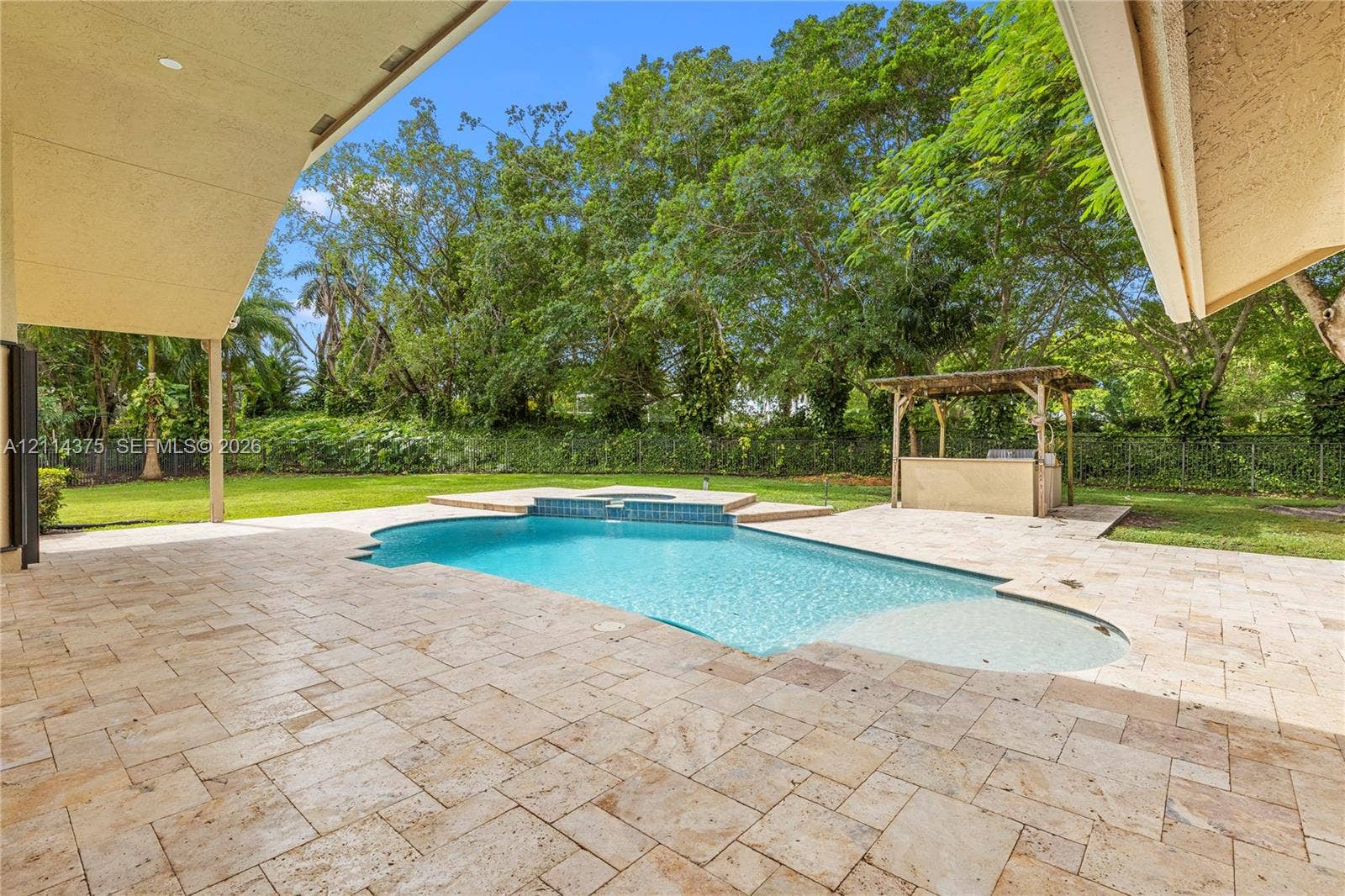 1206 S Manor Drive S, Weston, Weston, FL 33326 Covered patio featuring stone tile flooring, in-ground swimming pool with built-in spa, and a poolside pergola with an integrated bar