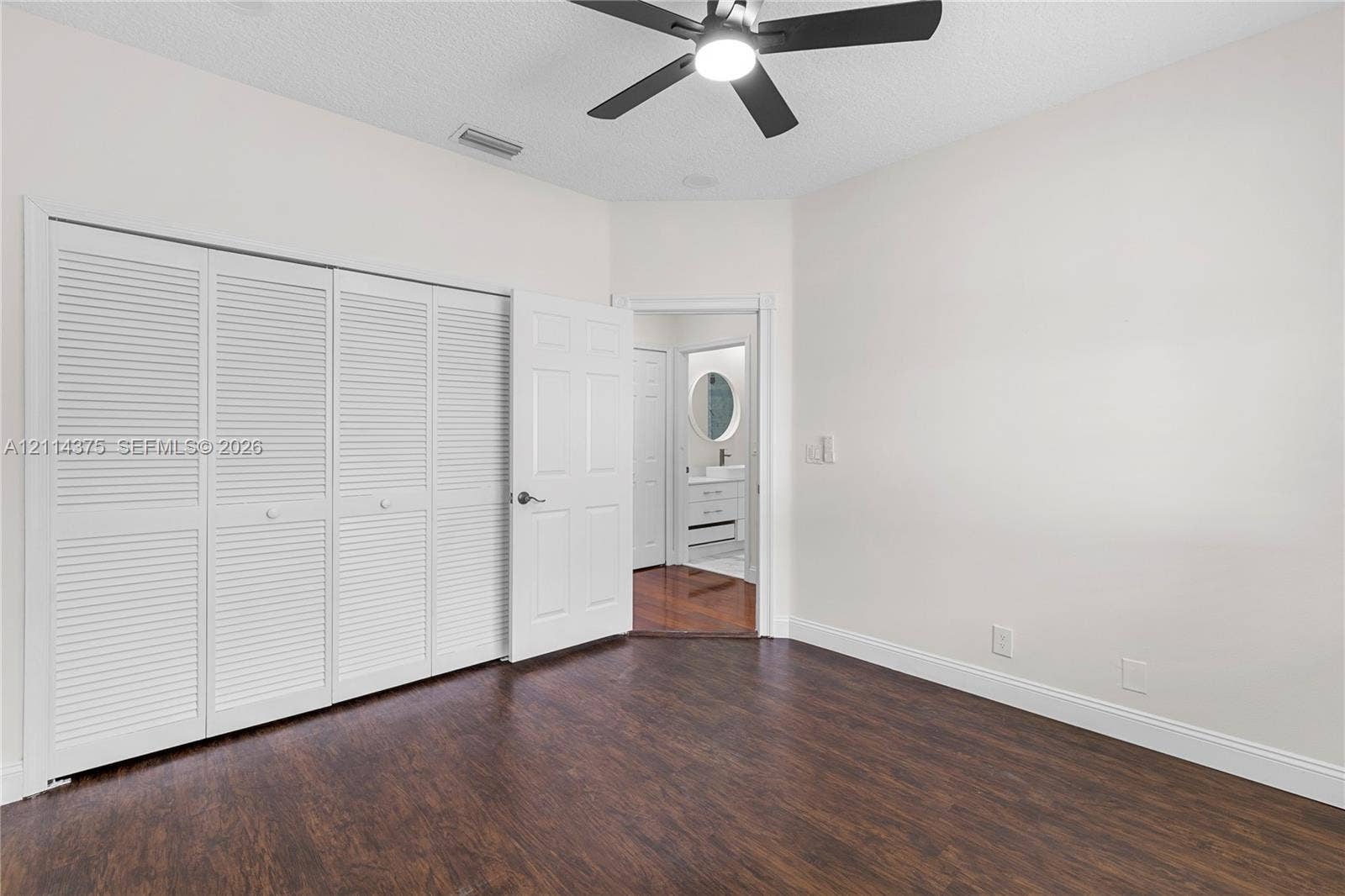 1206 S Manor Drive S, Weston, Weston, FL 33326 Wood-finish flooring, multi-panel louvered closet doors, and ceiling fan with integrated lighting
