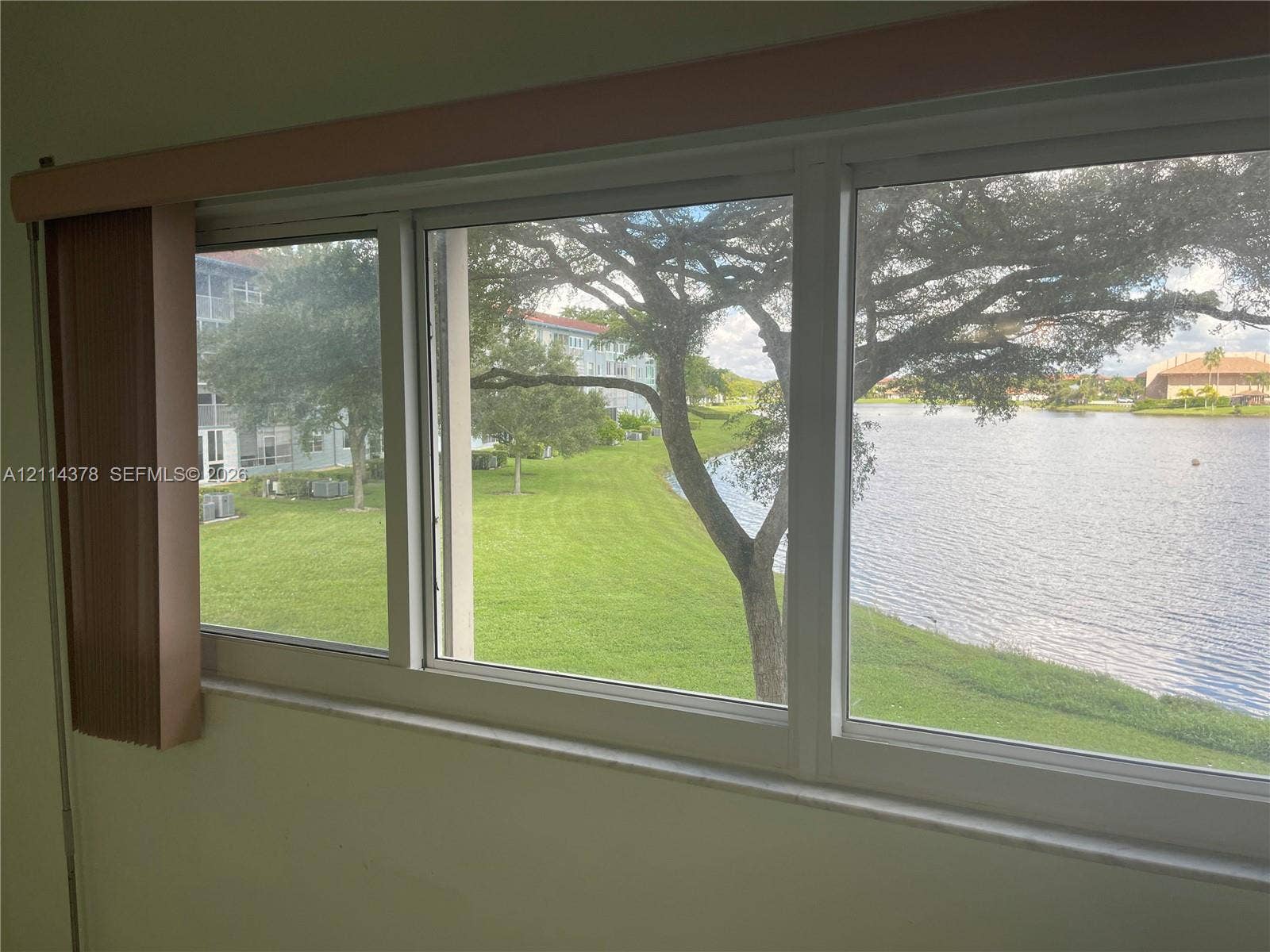 13355 SW 16th Court, #205E, Pembroke Pines, FL 33027 Large horizontal multi-pane windows with white framing, including a stone-finish sill