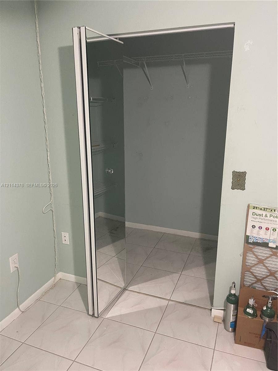 13355 SW 16th Court, #205E, Pembroke Pines, FL 33027 Storage space featuring mirrored bypass closet doors and wire shelving