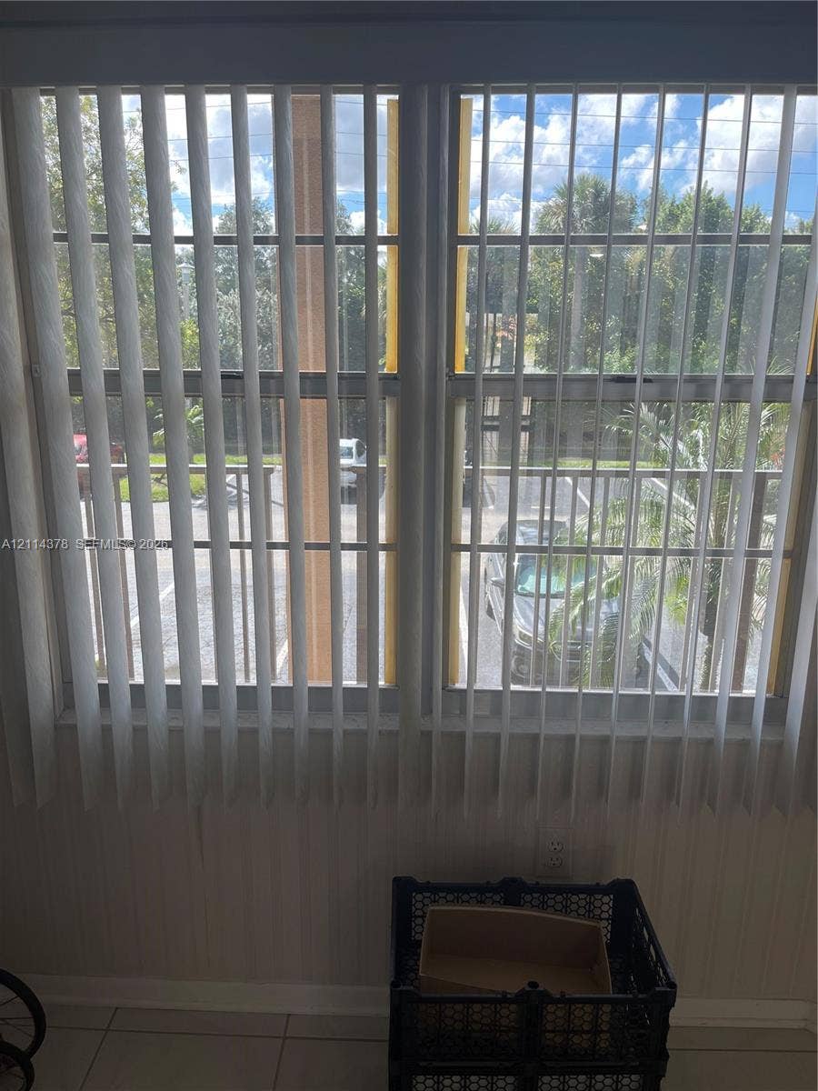13355 SW 16th Court, #205E, Pembroke Pines, FL 33027 Dual-pane windows featuring vertical blinds and light-tone tile flooring